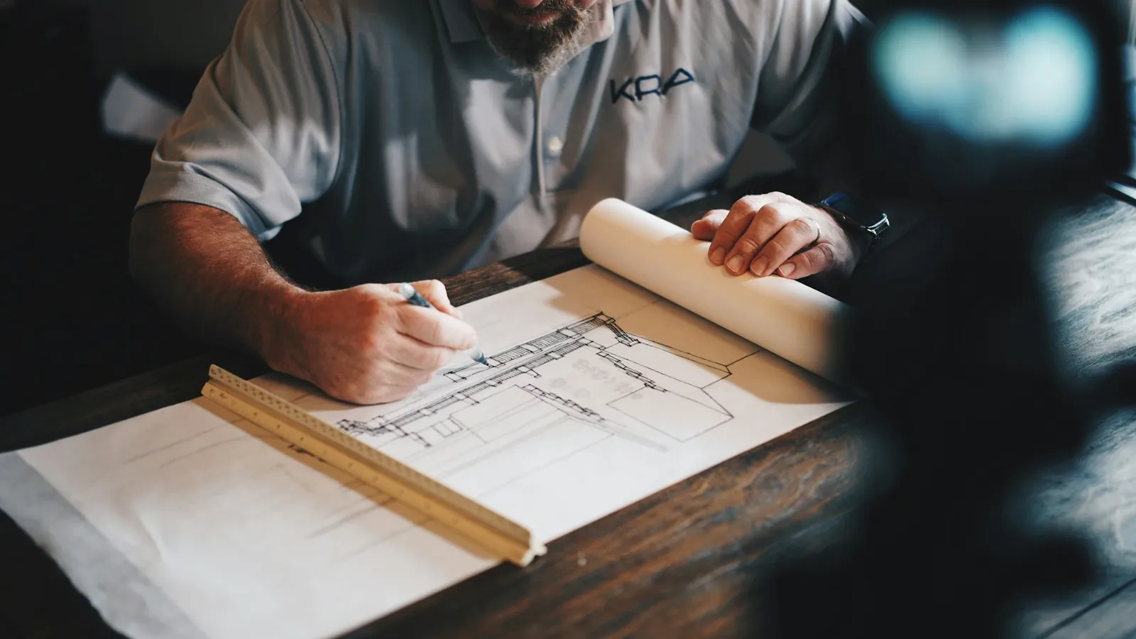 Architect drafting floor plans by hand on a drawing table