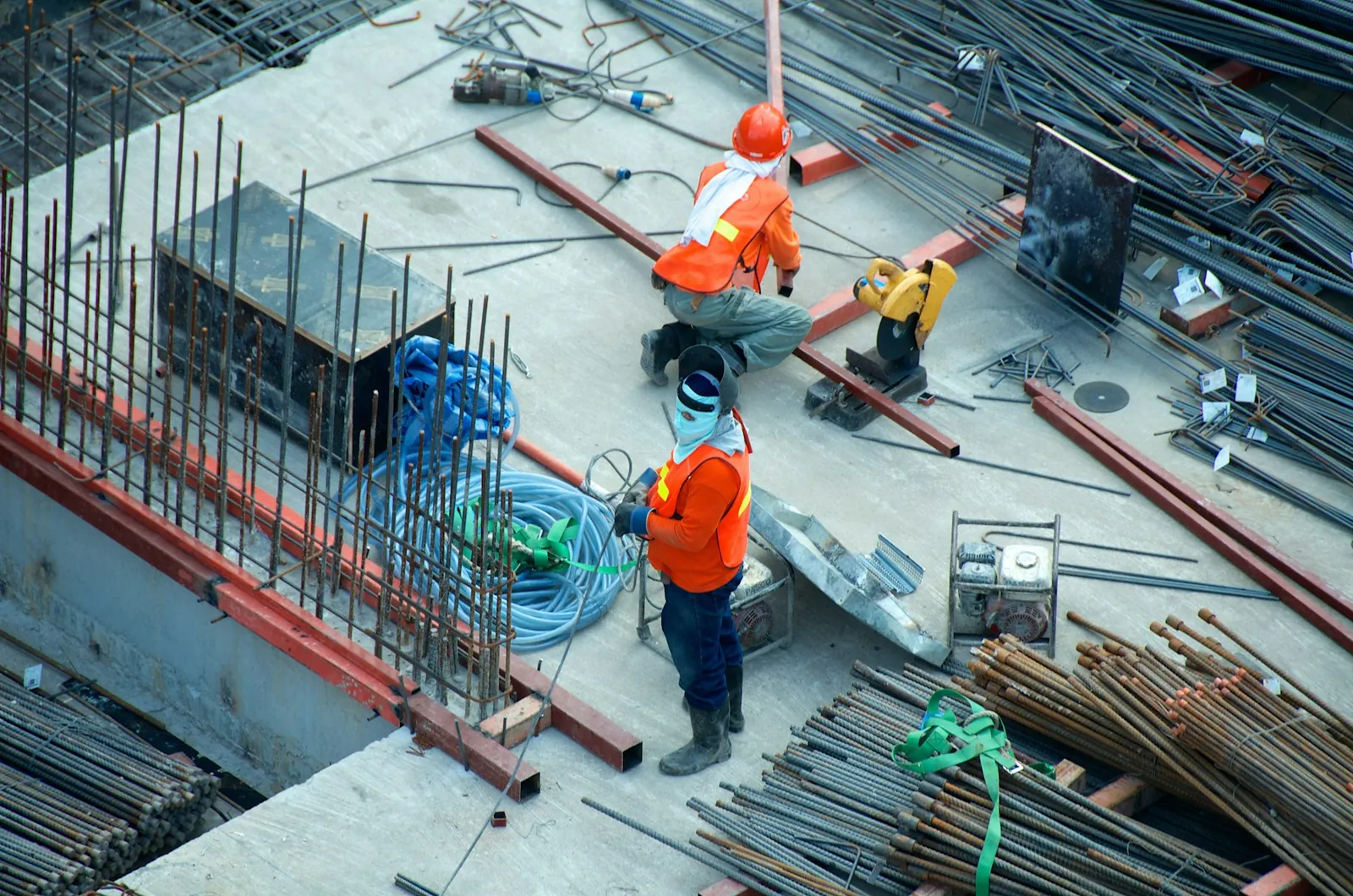 Construction site with reinforcement steel and workers on a residential structure
